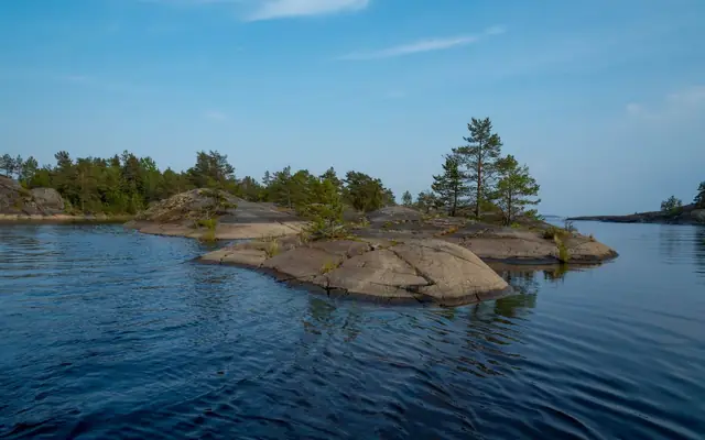 Peaceful view of rocky islands with trees in Lake Ladoga, Karelia, Russia.