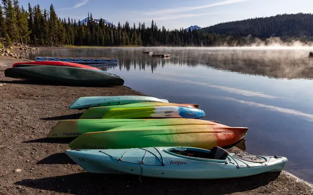 Canoes on a calm lake in the morning mist